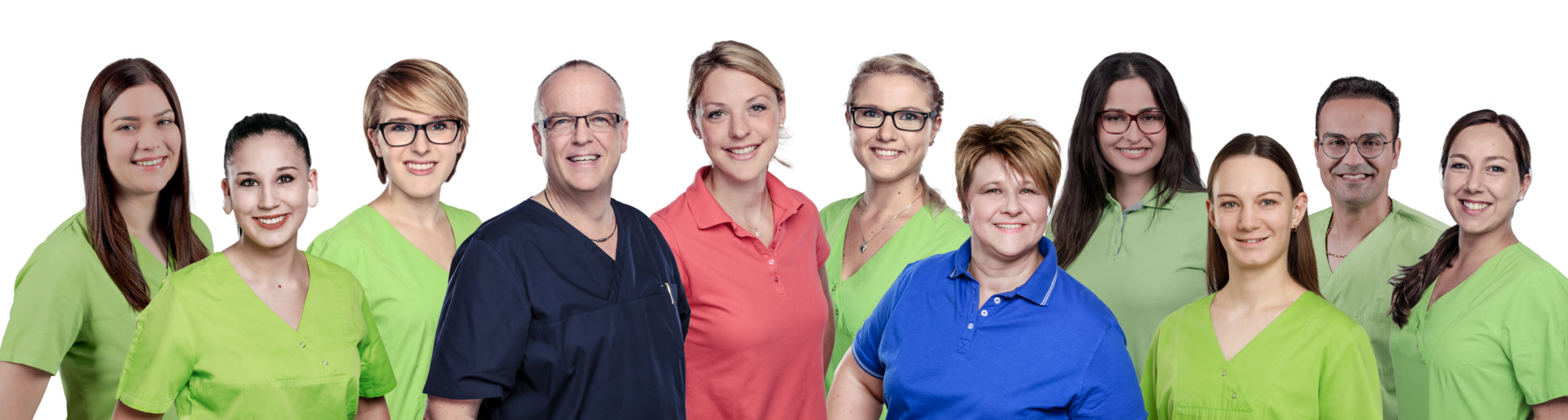Group of diverse healthcare professionals standing together, smiling, wearing colorful scrubs